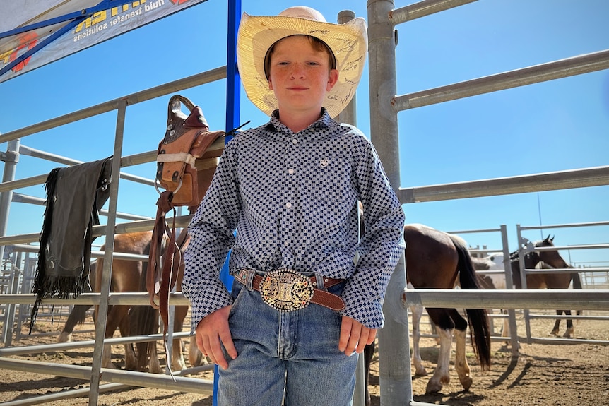 Young cowboy Rylee Remfrey wears cowboy hat and hands on hips
