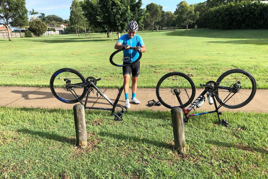 A man changes tyre on his bike at Birkdale Road