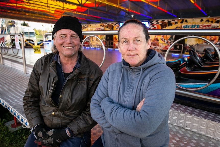 Edwin and Selina Bell sit in front of the dodgem cars ride.