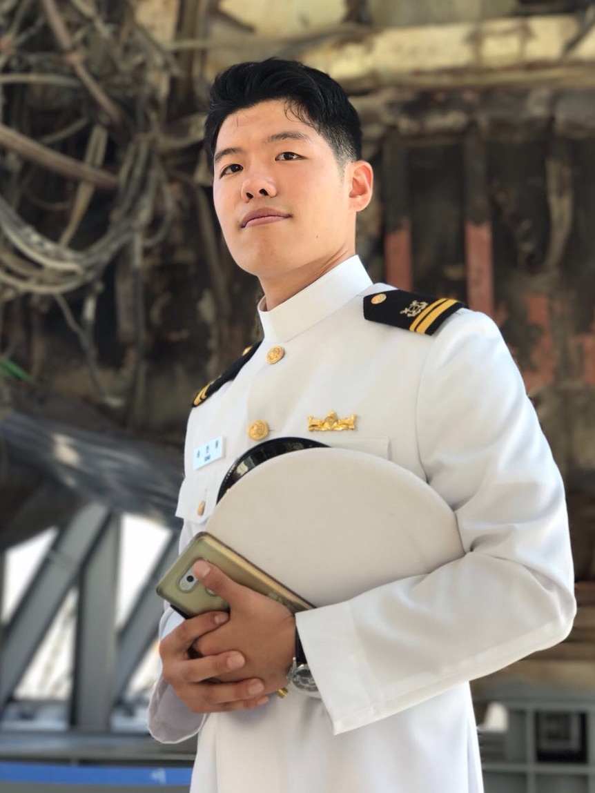 Han Woong Song poses with his hat at the military base