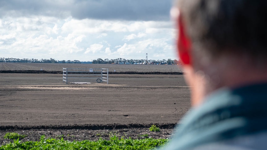 A photo over Ian Hayllor's shoulder of a drill rig operating in the distance near Dalby, June 2021.