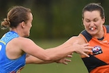 Alyce Parker of the GWS Giants holds off Gold Coast Suns' Britt Perry in their AFLW match.