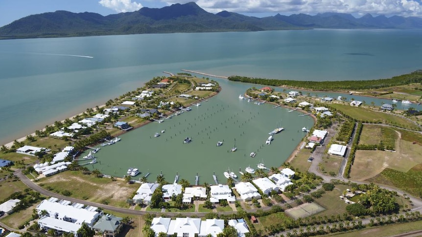 Aerial short of Port Hinchinbrook residential resort and nearby Hinchinbrook Island