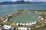 Aerial short of Port Hinchinbrook residential resort and nearby Hinchinbrook Island