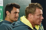 Bernard Tomic looks at Lleyton Hewitt as he speaks during a Davis Cup press conference. Nick Kyrgios is sitting nearby.