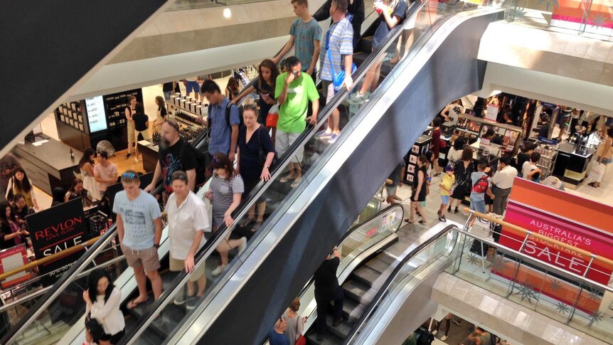 Shoppers on escalators in Myer in Perth's CBD.