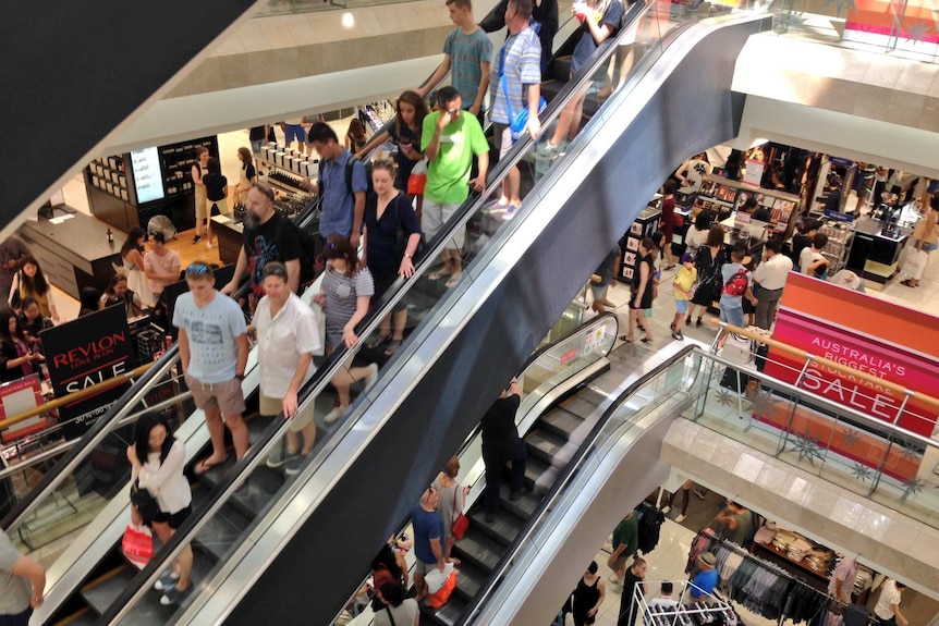 Shoppers on escalators in Myer in Perth.