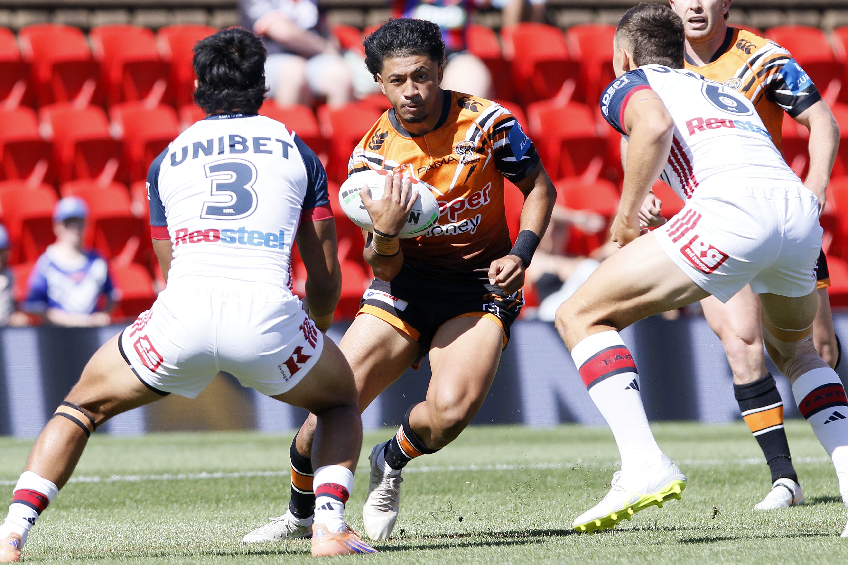 Faaletino Tavana running with the ball, approaching two defenders