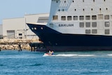 A jetski passes the MV Bahijah