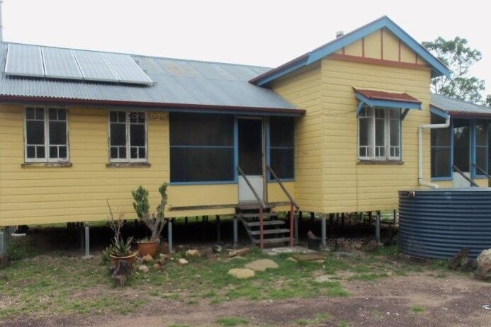Yellow, Queenslander-style house on Wains Road, Wieambilla, that was the scene of a deadly police shooting