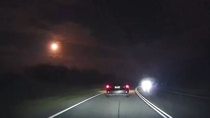 The meteor seen as a bright flash in the night sky.