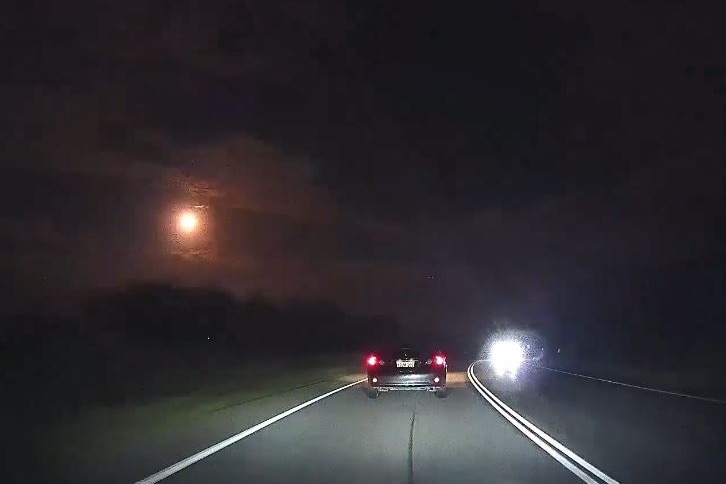 The meteor seen as a bright flash in the night sky.