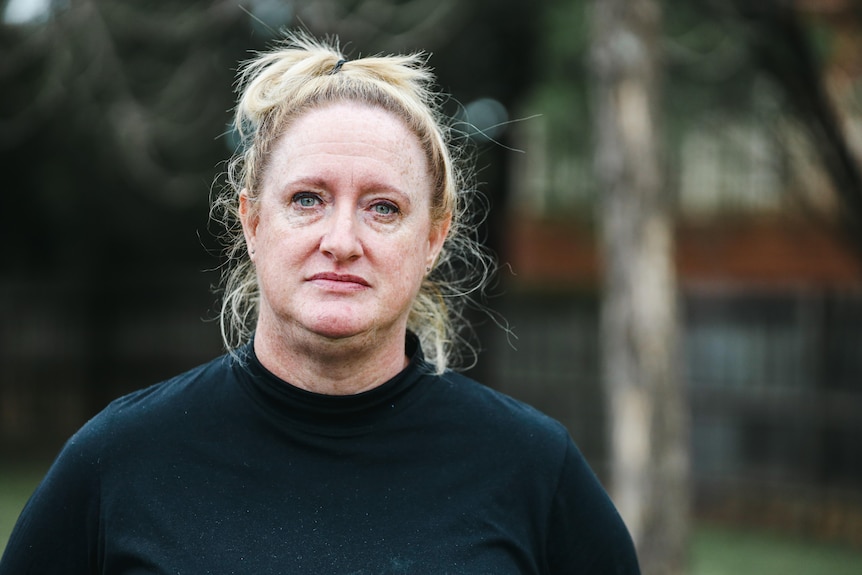 A woman with blonde hair and a black jumper