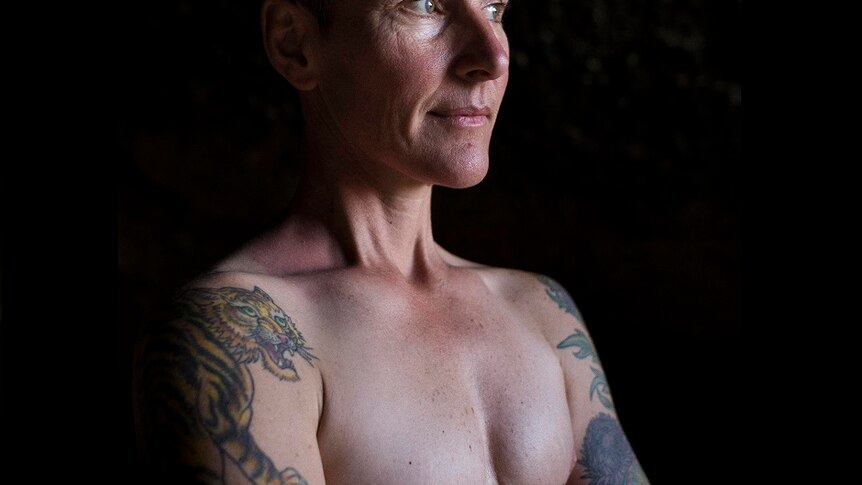 Eddie Ayres shirtless, showing the mastectomy scars on his chest.