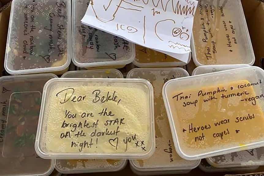 Food containers scrawled with mesages of support for nurses and one with a return message of thanks for Bekk.