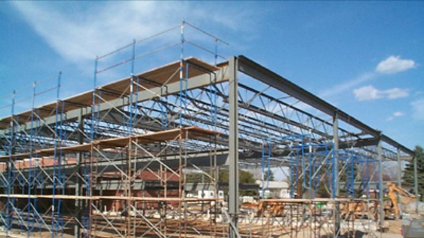 A half-built building stands on a construction site at a school