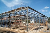 A half-built building stands on a construction site at a school