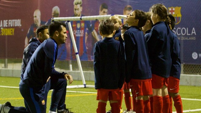 Coaches kneel to talk to young players