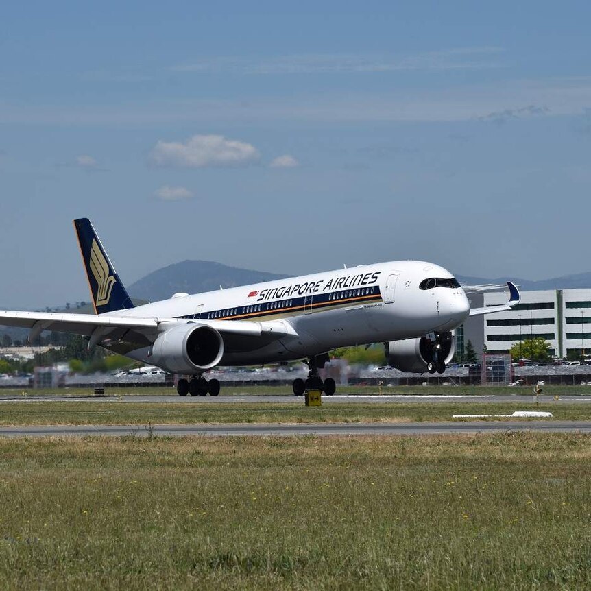 A Singapore Airlines flight touches down in Canberra.