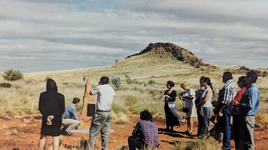 A small crowd watches as a plaque is unveiled to commemorate the crew of the crashed Viscount plane.