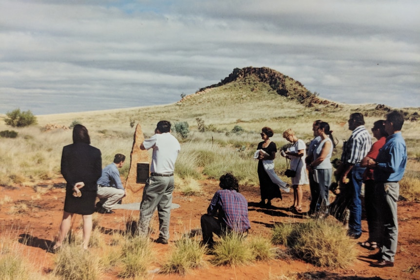 A small crowd watches as a plaque is unveiled to commemorate the crew of the crashed Viscount plane.