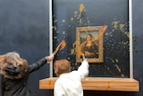 Two people throw soup towards a painting.