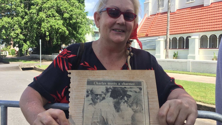 Cairns resident Leila Sherwood, holding an old newspaper clipping, hopes to meet Prince Charles again during his visit.