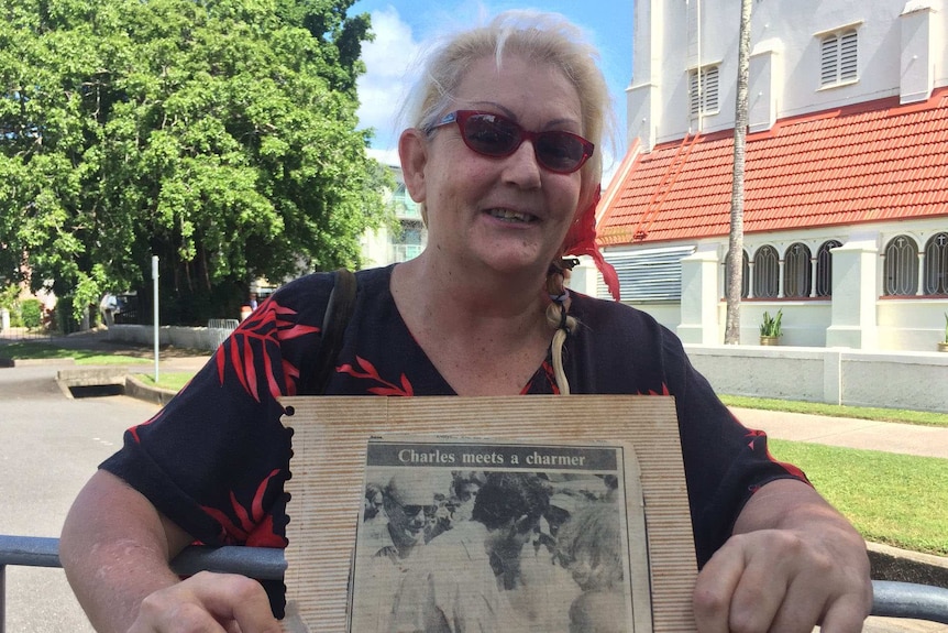 Cairns resident Leila Sherwood, holding an old newspaper clipping, hopes to meet Prince Charles again during his visit.