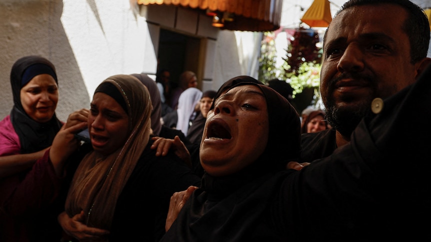Mourners crying during a funeral. 