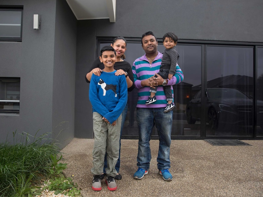 Doreen Moreira and Saravanan Sivalinggam with their boys at the front of their home