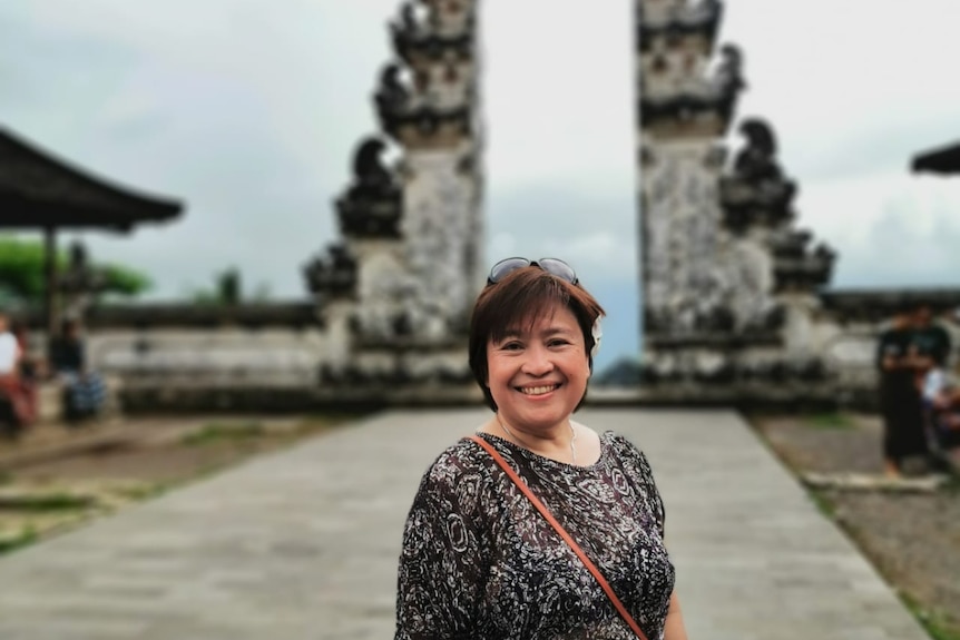 Lilie Chow standing in front of a balinese gate.