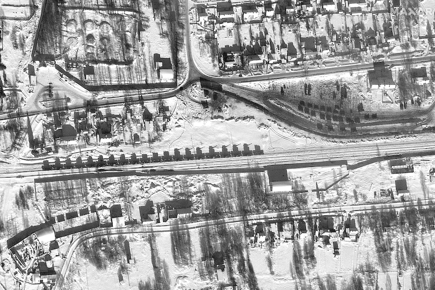 Satellite image shows armor and artillery loaded on flatcars in a railyard