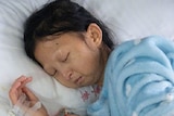 Chinese student Wu Huayan is sleeping in bed at a hospital.