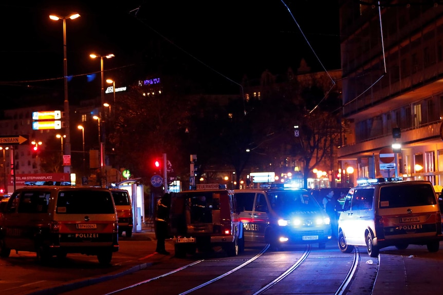 Police vans block a street in Vienna.