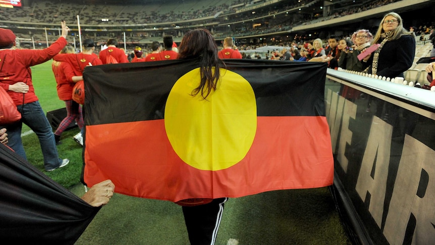 Volunteers walk the Long Walk from the city to the MCG as part of the "Dreamtime at the G".