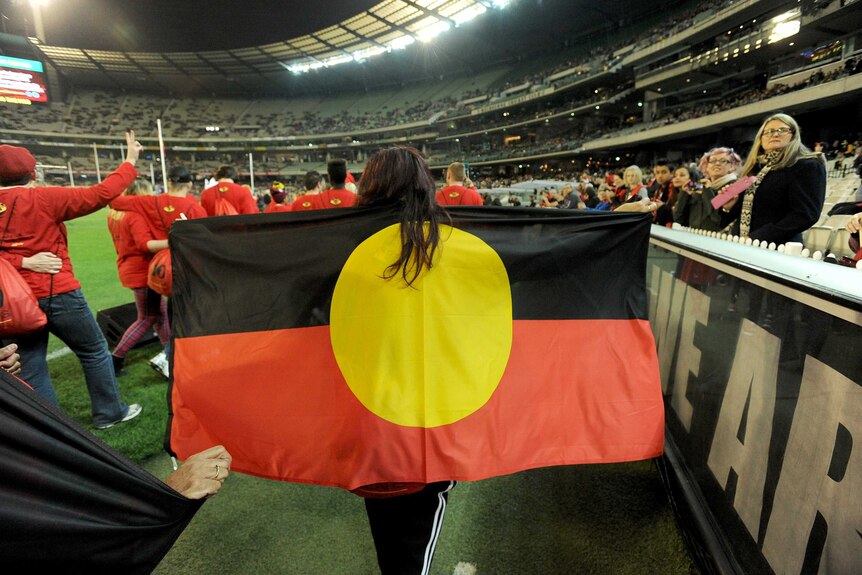 Volunteers walk the Long Walk from the city to the MCG as part of the "Dreamtime at the G".