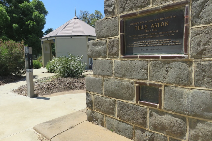 A bluestone cairn with a plaque on it honouring Victorian woman Tilly Aston.