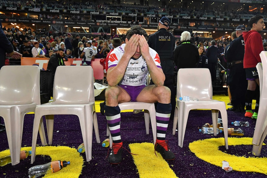 Billy Slater sits with his face in his hands after the Storm lost to the Roosters in the NRL grand final.