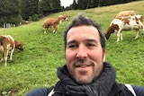 Councillor Jeremy Rich captures a photo of himself with cattle grazing in the background.