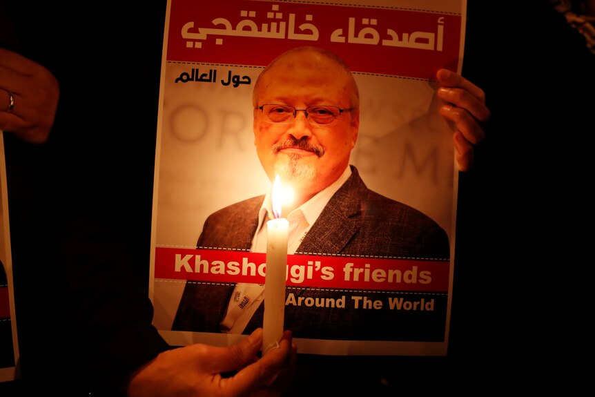 A demonstrator holds a poster with a picture of Saudi journalist Jamal Khashoggi 