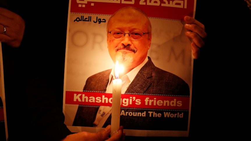 A demonstrator holds a poster with a picture of Saudi journalist Jamal Khashoggi 