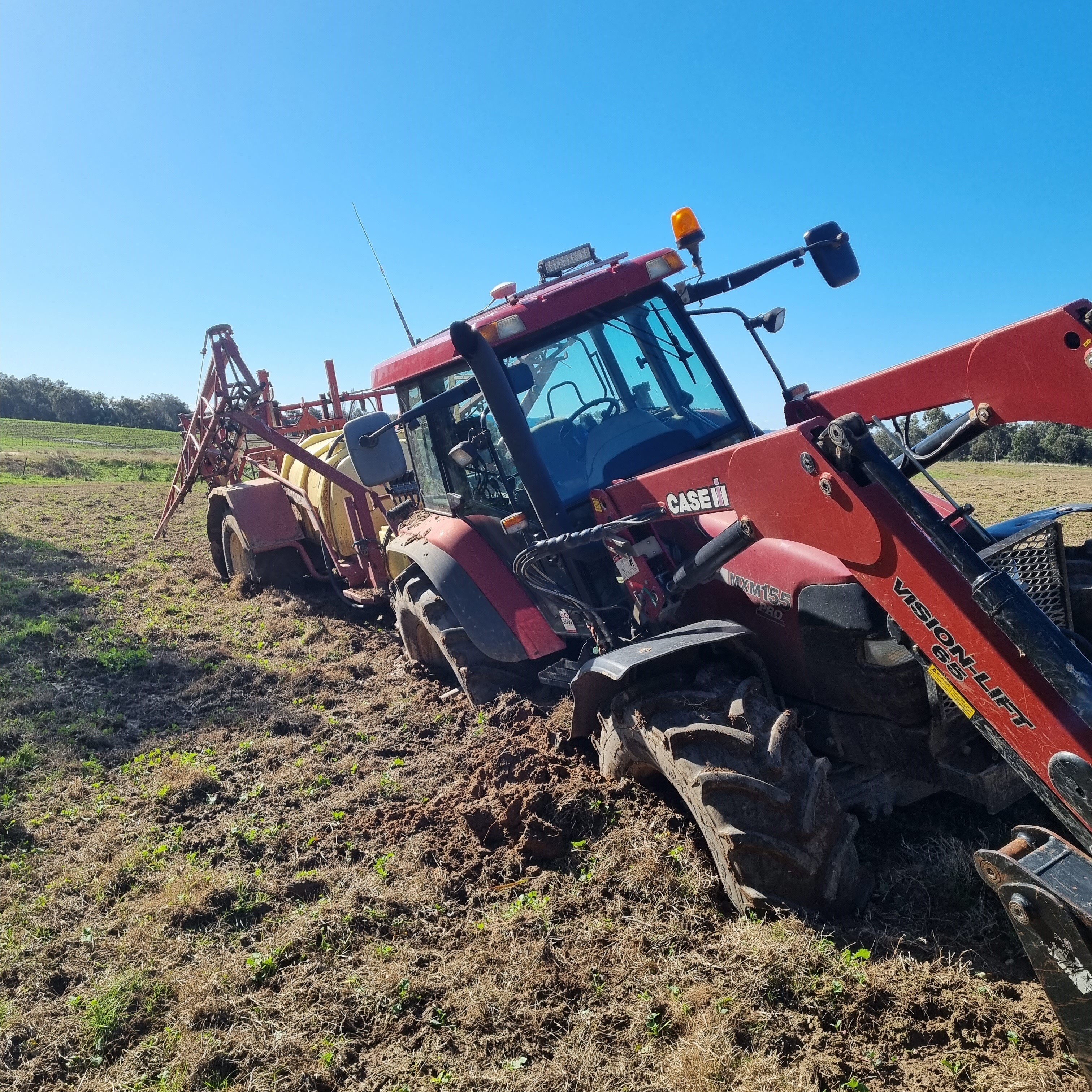 A badly bogged tractor on a farm.