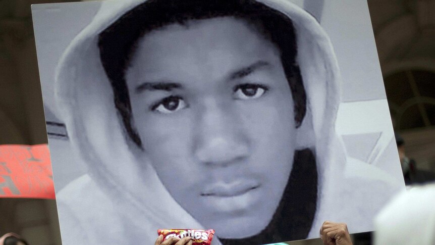 Photo of Trayvon Martin held in a crowd.