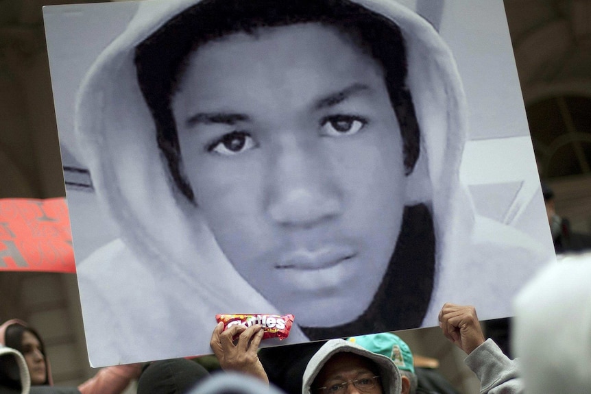 Photo of Trayvon Martin held in a crowd.