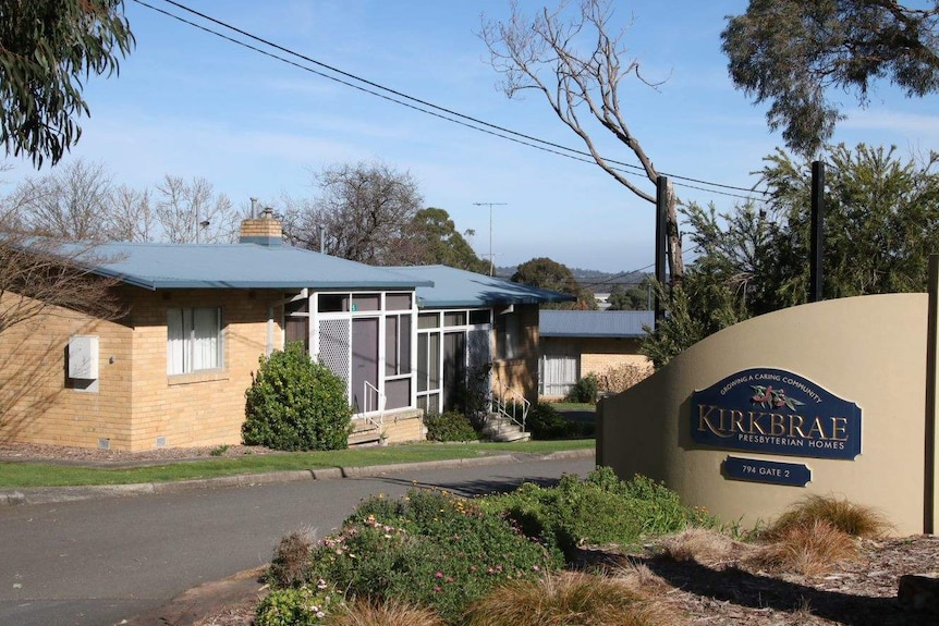 Single storey cream brick buildings with a sign reading Kirkbrae.