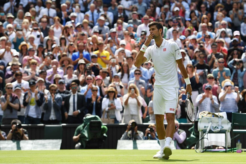 Novak Djokovic blows kisses to the crowd at Wimbledon