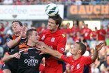 Roar and Reds battle for ball