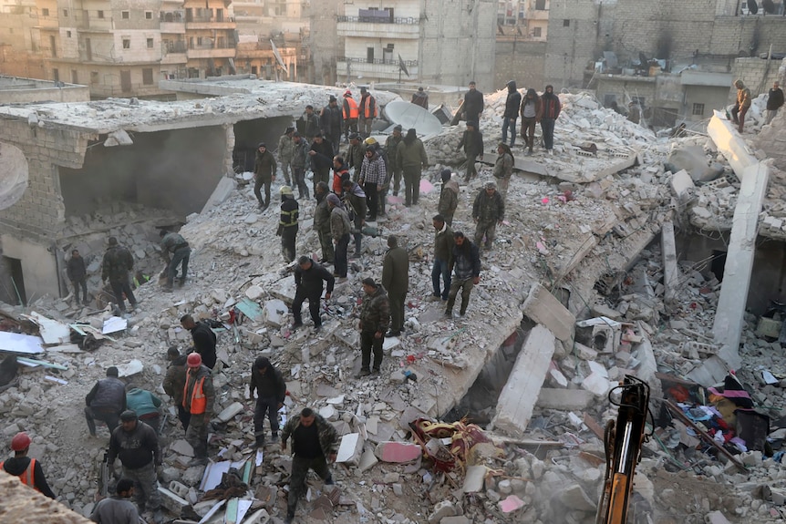 People at the site of a building collapse in Aleppo, Syria.