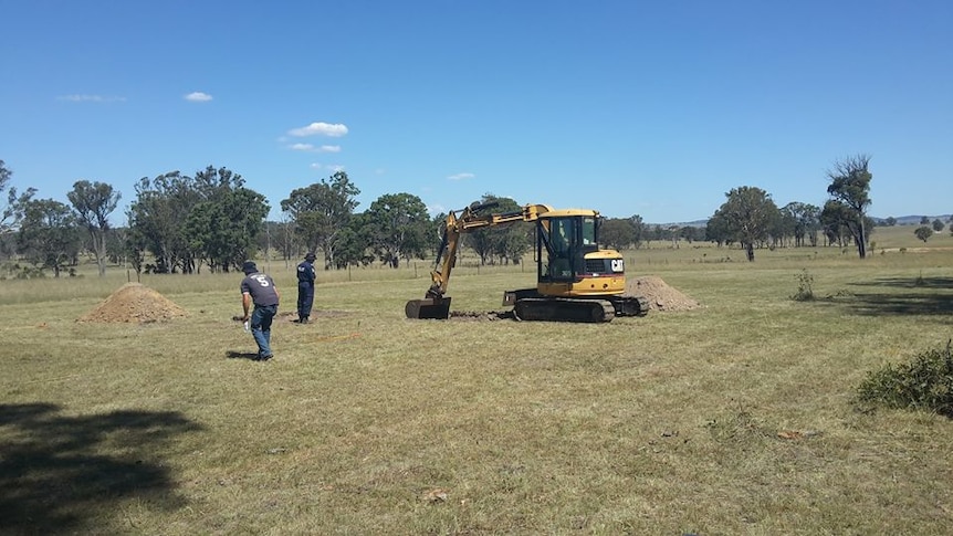 NSW police use an excavator to dig up a paddock near Armidale in the search for a man who disappeared for than two decade ago