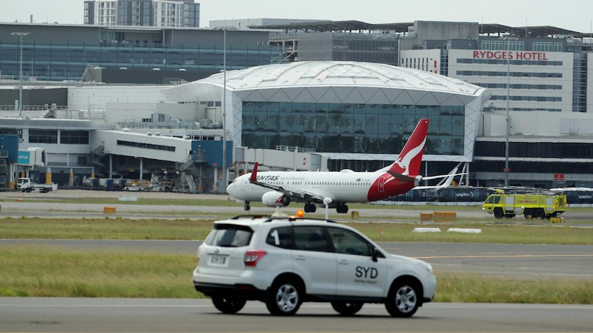 A car in front of a plane